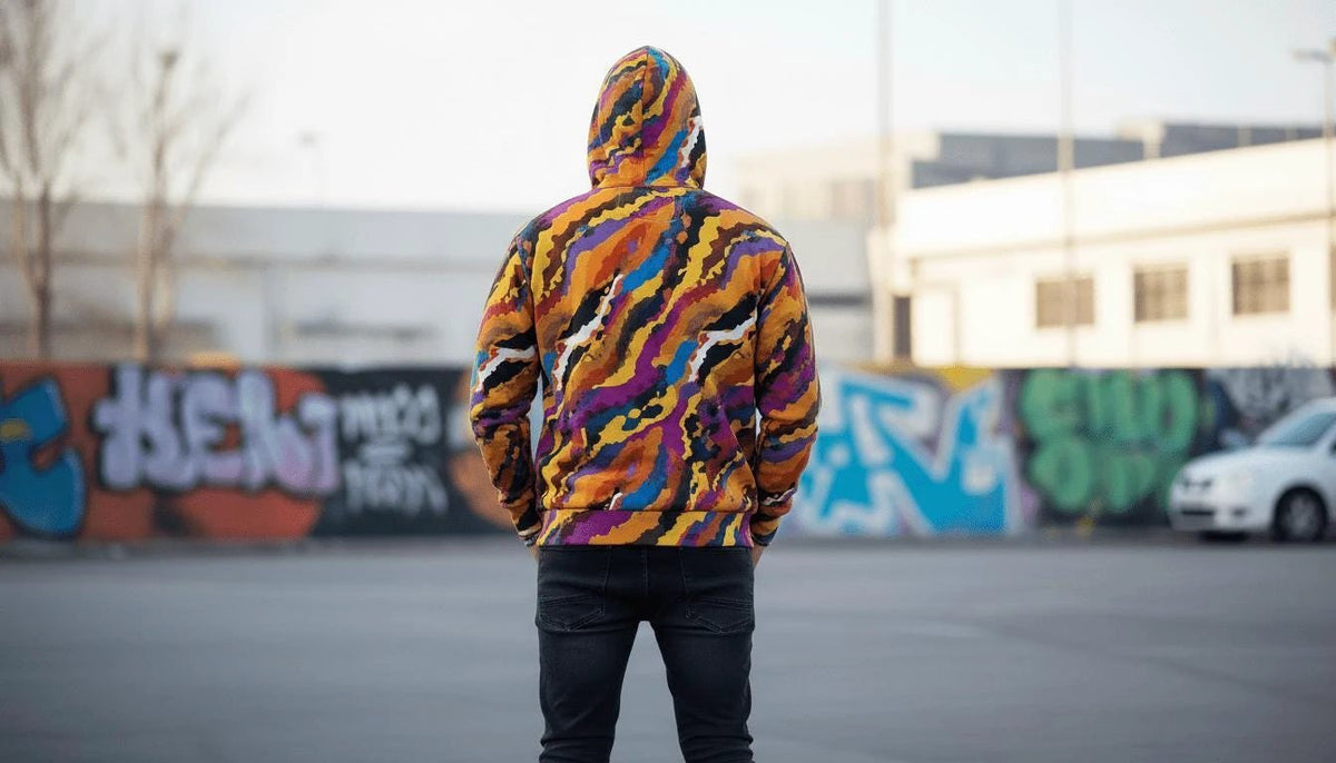 Painted strata zip hoodie detail showing layered amber and cobalt brush strokes
