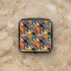 Black hardshell Nintendo Switch 24-slot game card case with colorful abstract brushstroke paint pattern in teal, orange, pink, black, and green