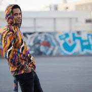 Painterly streetwear zip hoodie with sunset-inspired all-over print and ribbed cuffs