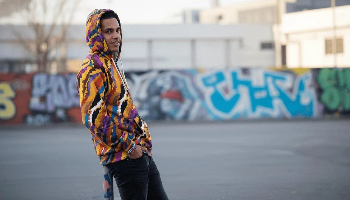 Painterly streetwear zip hoodie with sunset-inspired all-over print and ribbed cuffs