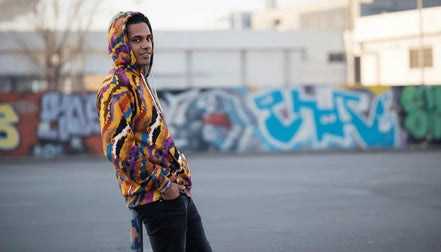 Painterly streetwear zip hoodie with sunset-inspired all-over print and ribbed cuffs