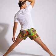 Neon Radial Burst Athletic Shorts - Vibrant Psychedelic Swim Trunks for Bikram Yoga & Rave Fitness by Aesthetic Rebellion
