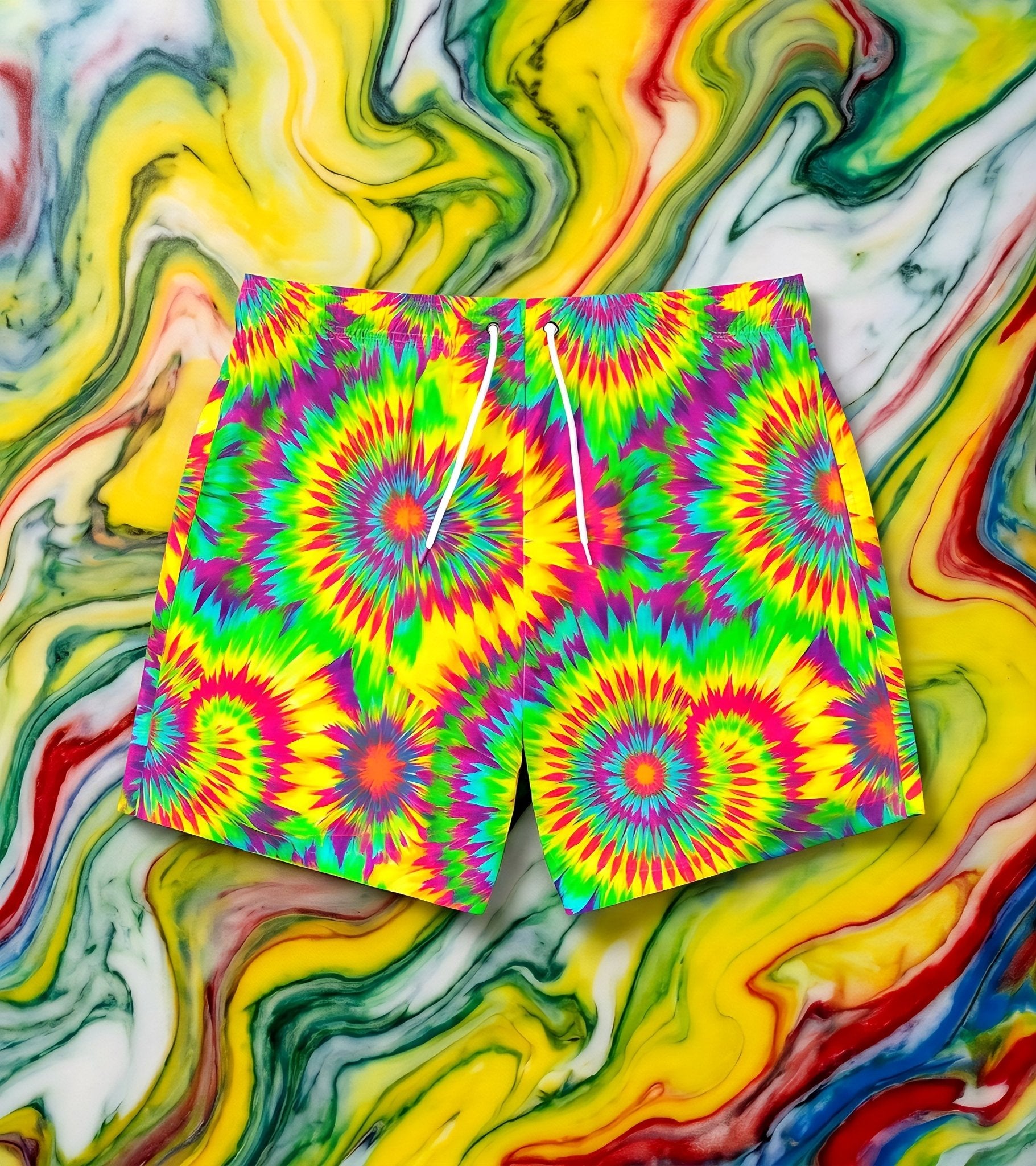 Acid Lime Tie-Dye swim trunks by Dyles Mavis — neon all-over print of tie-dye spirals in lime green, magenta, yellow and cyan with white drawstring, front flat lay