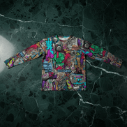 Aerosol Alchemists long sleeve tee by Dyles Mavis — dense graffiti sticker-bomb all-over print with spray cans, tags and street art panels in magenta, teal and green, front flat lay on marble