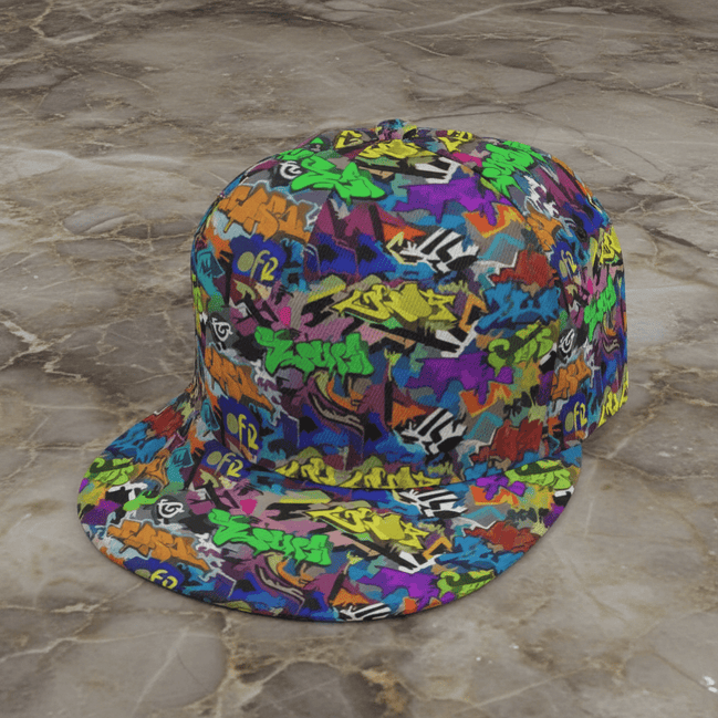 Graffiti Wildstyle snapback cap by Dyles Mavis — flat brim 6-panel cap with all-over print of neon green, purple and orange wildstyle graffiti tags, angled product shot on marble
