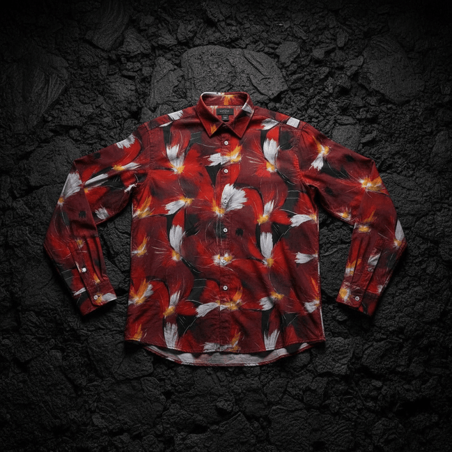 Crimson Plume Bloom long sleeve polo by Dyles Mavis — 220gsm polo shirt with all-over print of painterly crimson and white plumed floral blooms on a black ground, front flat lay
