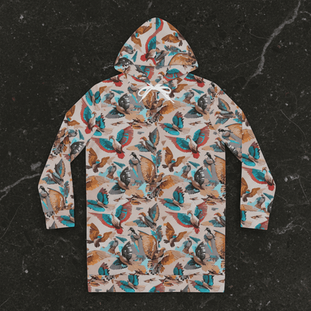 Aviary Fieldbook hoodie dress by Dyles Mavis — women's mid-thigh pullover hoodie dress with all-over print of a maximalist bird and botanical collage in teal, rust, tan and grey, back view flat lay on dark marble