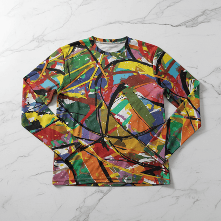 Boundless Bleeds long sleeve tee by Dyles Mavis — crew neck long sleeve shirt with all-over print of abstract expressionist paint splatter in red, yellow, blue, green and black, front flat lay on marble