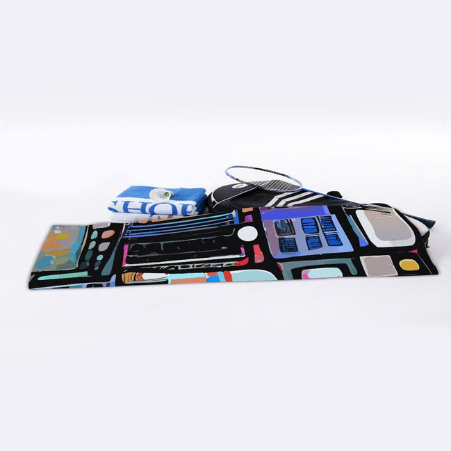 Blue Hour Collage sports towel by Dyles Mavis — cooling towel with all-over print of an abstract painterly collage in navy, coral, teal and cream blocks, rolled with a tennis racquet and water bottle