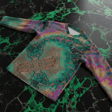 Cosmic Abstract hockey jersey by Dyles Mavis — full-coverage jersey with all-over print of a marbled organic cell composition in teal, magenta, gold and black, front flat lay on green marble
