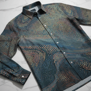 Echo Chamber AOP Imitation Silk Shirt — swirling pointillist dot wave pattern in amber, gold, terracotta on deep teal. Fluid long-sleeve button-down. Aesthetic Rebellion.