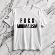 F Minimalism Slogan Tee — bold black FUCK MINIMALISM typography on white Airlume cotton tee with small circular sleeve logo. Anti-minimalism statement shirt by Aesthetic Rebellion.