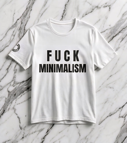 F Minimalism Slogan Tee — bold black FUCK MINIMALISM typography on white Airlume cotton tee with small circular sleeve logo. Anti-minimalism statement shirt by Aesthetic Rebellion.