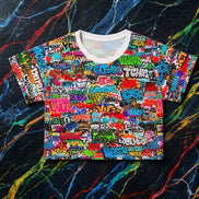 Graffiti Bomb Crop Tee with dense all-over graffiti throw-ups and bomb lettering in vivid multicolor on white ribbed collar