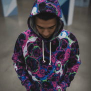 Neon Cell AOP Hoodie in dark ground with full-coverage neon magenta, purple, and blue organic cellular pattern, front view flat lay