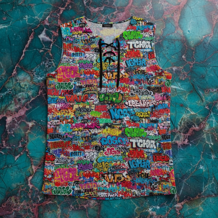 Tag Wall Lace-Up Tank cotton-blend sleeveless with lace-up V-neck detail, dense neon graffiti lettering in teal, pink, green, orange, yellow on white, flat lay on teal marble