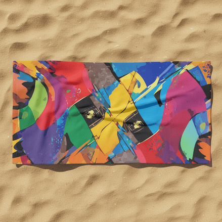 Kinetic Collage Beach Towel on sand with bold abstract color collage in red, green, purple, gold, blue, and magenta with black accents, full edge-to-edge print