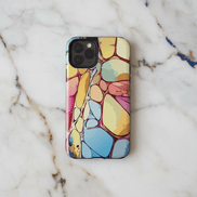 Chalk Stone iPhone Case on marble surface showing pastel organic stone cell pattern in butter yellow, rose pink, sky blue, and sage green with deep red vein lines, on iPhone Pro model