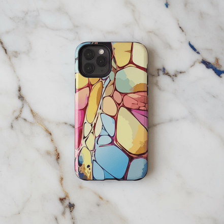 Chalk Stone iPhone Case on marble surface showing pastel organic stone cell pattern in butter yellow, rose pink, sky blue, and sage green with deep red vein lines, on iPhone Pro model