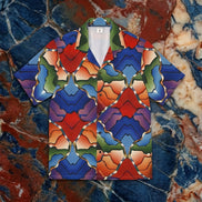 Gradient Kaleidoscope Camp Shirt with mirrored airbrush gradient tile pattern in cobalt blue, red, green, and amber diamond symmetry, camp collar, flat lay on red marble