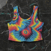 Tie-Dye Spiral Crop Tank fitted cut with classic rainbow spiral tie-dye in red, blue, yellow, and orange at full saturation, flat lay on black marble