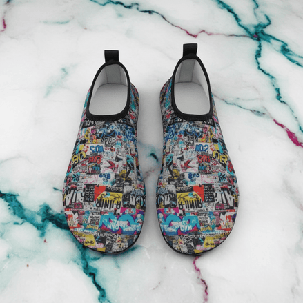 Sticker Bomb Water Shoes pair with dense sticker and poster collage print on quick-dry elastic uppers with black soles, on white marble