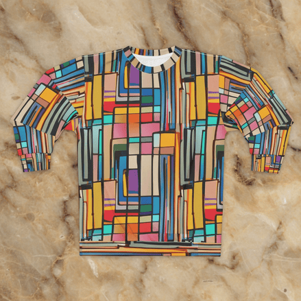 Stained Glass Block Sweatshirt with vertical stacked color block pattern in coral, cobalt, gold, teal, and pink divided by dark leading lines, flat lay on marble