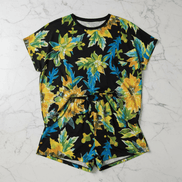 Pajama set with large yellow sunflower and green foliage all-over print on black background, t-shirt and shorts